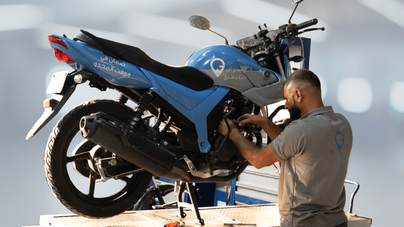 Mechanic servicing a delivery bike in the workshop of Gulf Way delivery solutions Dubai UAE